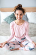 © BestForYou - Beautiful young smiling woman yoga in the lotus position at home.