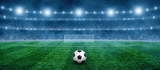 Fototapeta Sport - Soccer ball on green stadium