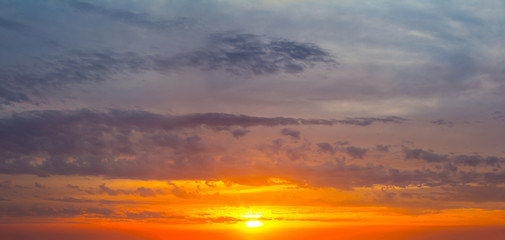 dramatic sunset among a dense clouds, natural background