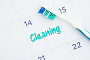 Wall Mural - Schedule a dental cleaning message on a calendar with a toothbrush