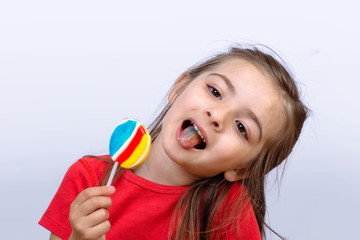 little girl eating a lollipop.