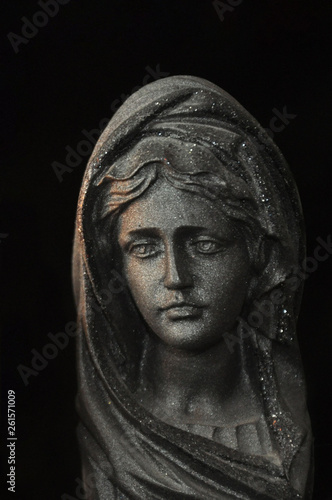 Fotografía Holy Virgin Mary in the rays of sunlight on a black background