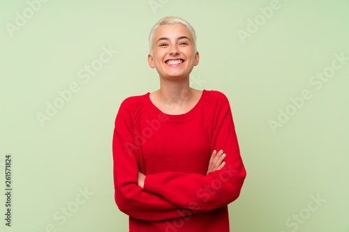 Teenager Girl With White Short Hair Over Green Wall Keeping The