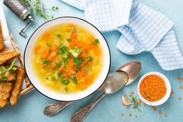 Lentil soup with vegetables and fresh parsley on plate