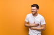 © luismolinero - Redhead man over brown wall smiling a lot