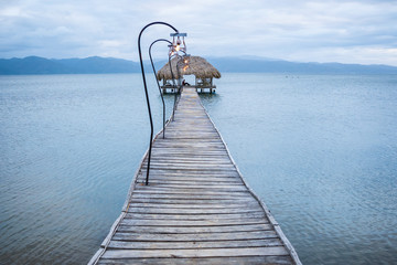 Wall Mural - Wooden dock and a rustic hut make up for a beautiful rural pier at the Gulf of Cariaco in Venezuela