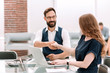 © yurolaitsalbert - businessman and businesswoman shaking hands over the Desk