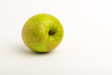 Two green ripe apple close up on a white background