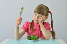 Child, Kid (little Girl) Does Not Want To Eat Broccoli