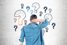 Man Scratching Head Looking At Question Marks