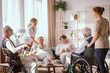 © Photographee.eu - Disabled grandparents spending time in common room with their caregivers