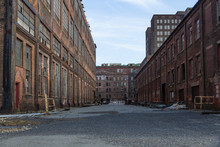Street Through A Complex Of Derelict Industrial Buildings, Daylight, Horizontal Aspect