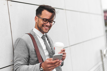 Young businessman sending message