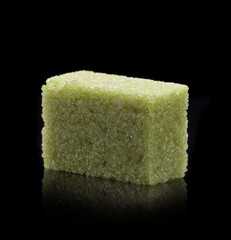 Sugar lumps piled up together against a black background