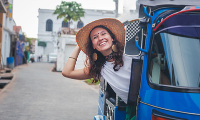 Young stylish european girl woman sitting in tuk-tuk traditional transport in Asia Galle, traditional transport in Sri Lanka, travel Ceylon Island