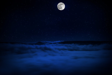 Wall Mural - mountain road through the forest on a full moon night. scenic night landscape of country road at nig