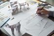 © Chaosamran_Studio - architect design working drawing sketch plans blueprints and making architectural construction model in architect studio