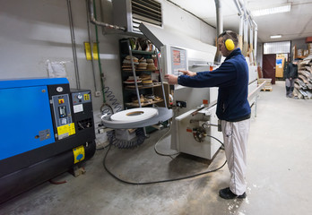 carpenter calculating and programming a cnc wood working machine