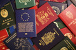 Mixed biometric passports of many countries of the world. In the foreground is a European Union passport.