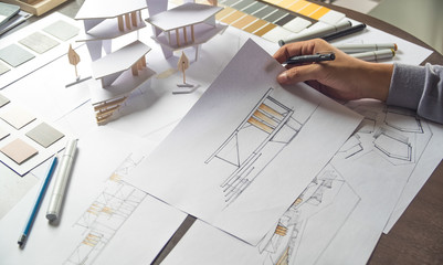 architect design working drawing sketch plans blueprints and making architectural construction model