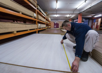 carpenter measuring wooden board