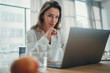 © SFIO CRACHO - Handsome businesswoman working on laptop at her workplace at modern office.Blurred background