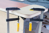Fototapeta  - Making furniture in the process, gluing furniture shields for making furniture.