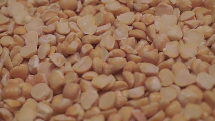 Poster - Chopped dried peas background. Macro view. Rotation 360 degrees.