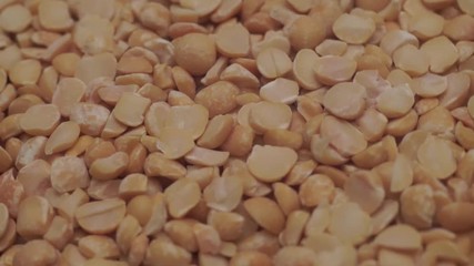 Poster - Chopped dried peas background. Macro view. Rotation 360 degrees.