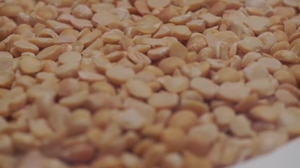 Poster - Chopped dried peas background. Macro view. Rotation 360 degrees.