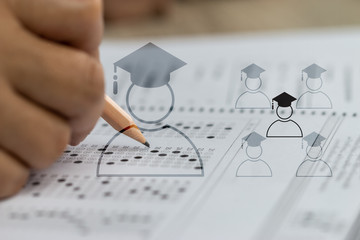 Wall Mural - education school test concept : hands student holding pencil for testing exams writing answer sheet 