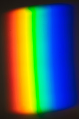 Rainbow created with prism, light projected on the wall