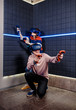 © Ilnur - young guy and girl in a virtual reality helmet playing video games in a club