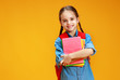 © JenkoAtaman - funny child school girl girl on yellow background    .