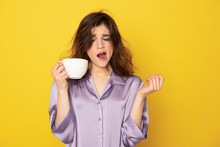 Sleepy Pretty Girl With Cup Of Coffee Yawning