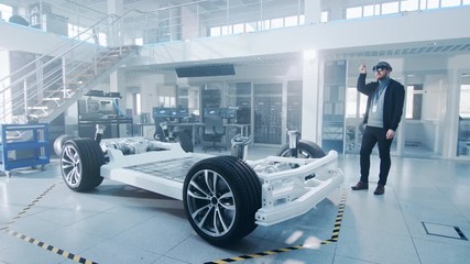 Poster - Automotive Engineer Working on Electric Car Chassis Platform, Using Augmented Reality Headset. In Innovation Laboratory Facility Concept Vehicle Frame Includes Wheels, Suspension, Engine and Battery.