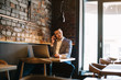 © Cressida studio - Young handsome man sitting in office with cup of coffee and working on project connected with modern cyber technologies. Businessman with notebook trying to keep deadline in digital marketing sphere.