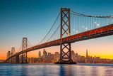 Fototapeta Sypialnia - San Francisco skyline with Oakland Bay Bridge at sunset, California, USA
