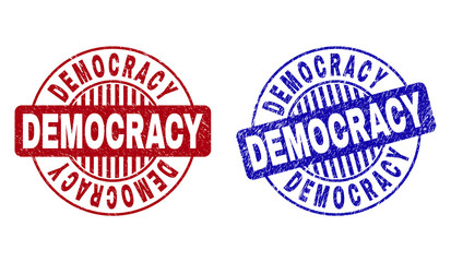 Grunge DEMOCRACY round stamp seals isolated on a white background. Round seals with grunge texture in red and blue colors. Vector rubber overlay of DEMOCRACY title inside circle form with stripes.