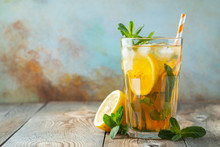 Traditional Iced Tea With Lemon And Ice In Tall Glass On A Wooden Rustic Table. With Copy Space