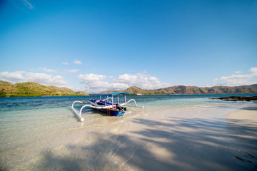 Empty traditional boat anchored on the beach