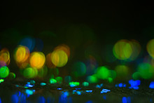 Defocused Colorful Bokeh Circles On Dark Background. Lens Flare Illuminated Glow. Abstract Design.