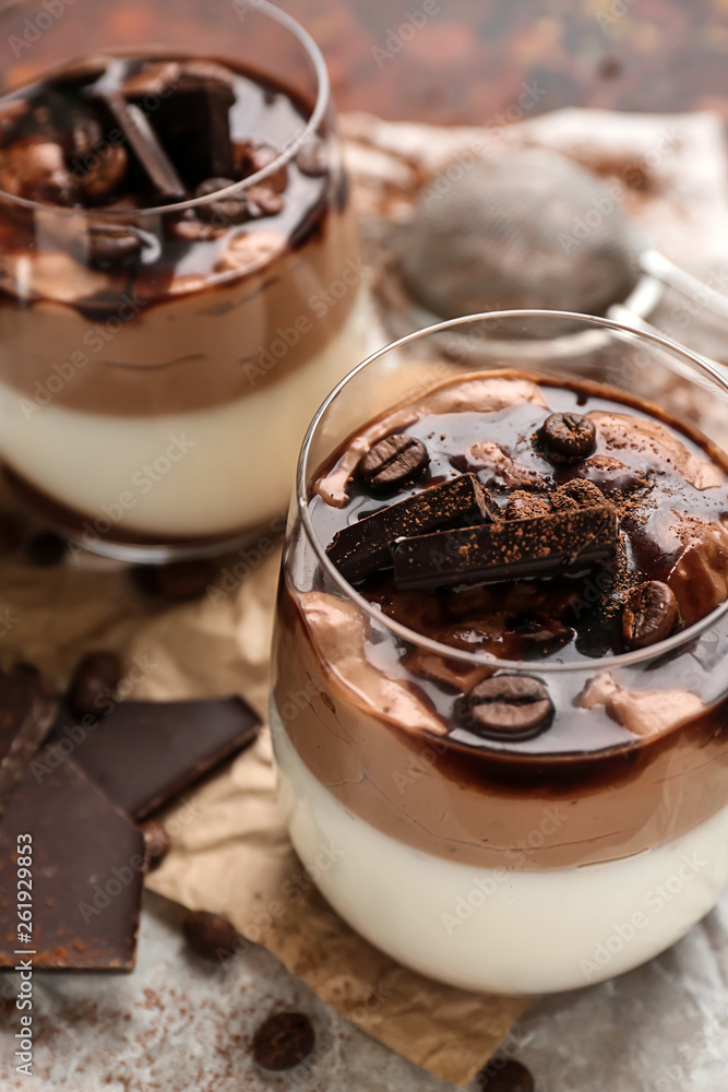 Glasses of delicious panna cotta on table