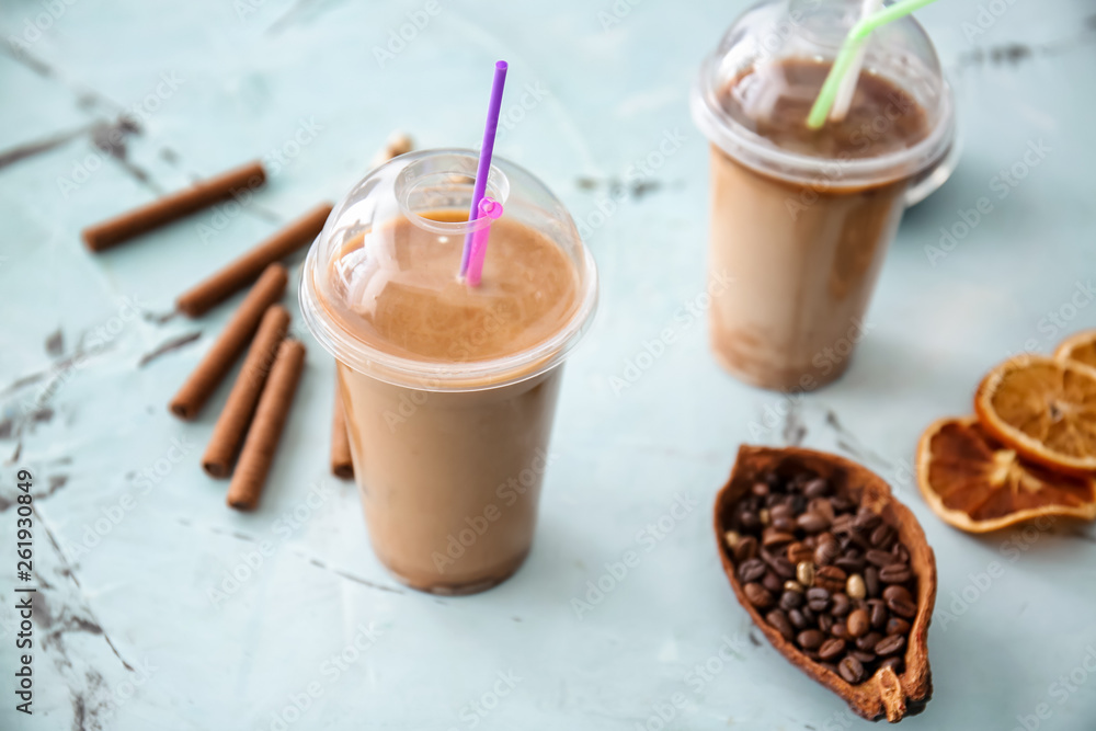 Cups of tasty frappe coffee on light table