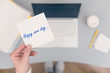 © flowertiare - Woman clerk sitting holding note paper sticker with Happy new day phrase. Business concept. Concept.