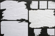 Several Sheets Of White Paper Pasted On A Black Wall.