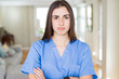 © Krakenimages.com - Beautiful young nurse woman at the clinic skeptic and nervous, disapproving expression on face with crossed arms. Negative person.