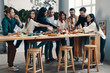 © gstockstudio - Feeling hungry. Full length of young people in casual wear eating pizza and smiling while having a dinner party indoors