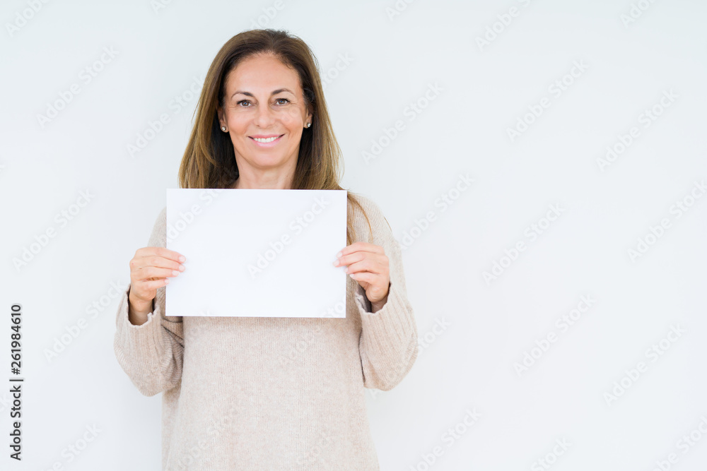 Middle age woman holding blank paper sheet over isolated background with a happy face standing and smiling with a confident smile showing teeth - obrazy, fototapety, plakaty 