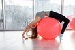 © RomanR - Woman in gym working with gymnastic ball